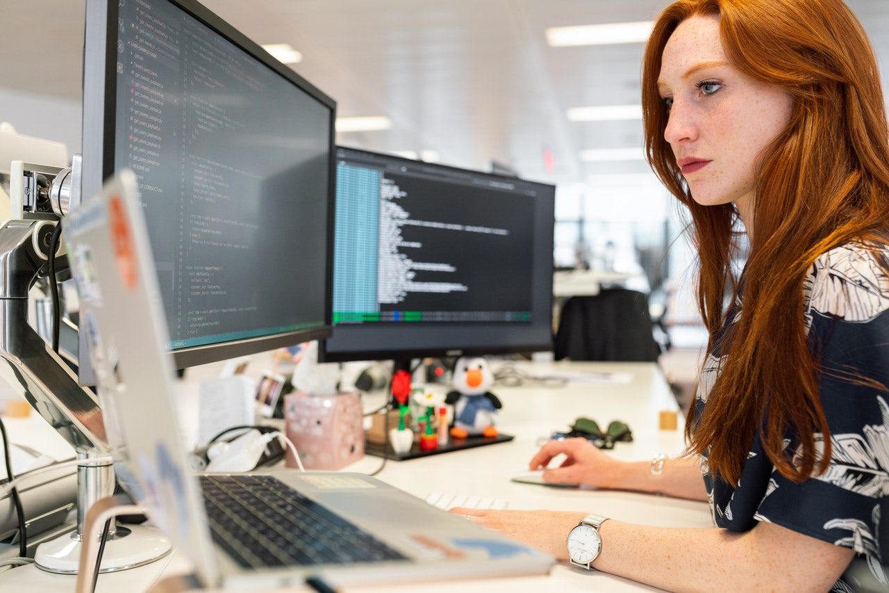 Picture of a person working at a computer.